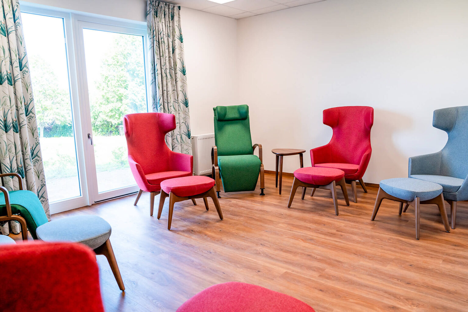 Moderne und gemütliche Inneneinrichtung des Pflegeheims in Stetten am kalten Markt mit farbenfrohen Sitzgelegenheiten.
